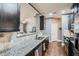 Modern kitchen featuring stainless steel appliances, dark cabinets and granite countertops at 2212 Knoxhill Se Vw, Smyrna, GA 30082