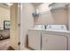 Convenient laundry room equipped with a washer, dryer, and overhead shelving at 2212 Knoxhill Se Vw, Smyrna, GA 30082