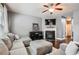 Cozy living room with modern ceiling fan, fireplace, and comfortable seating area with hardwood floors at 2212 Knoxhill Se Vw, Smyrna, GA 30082