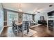 Open-concept living and dining room area with hardwood floors, contemporary furnishings, and abundant natural light at 2212 Knoxhill Se Vw, Smyrna, GA 30082