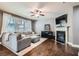 Inviting living area featuring a fireplace, ceiling fan, hardwood floors, and plush, comfortable seating at 2212 Knoxhill Se Vw, Smyrna, GA 30082