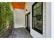 Outdoor balcony with dark gray tile, black railing and door, next to lush green trees at 2438 2Nd Nw St, Atlanta, GA 30318