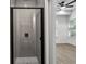 Modern bathroom featuring a glass-enclosed shower with white tiling and black trim, adjacent to a bright bedroom at 2438 2Nd Nw St, Atlanta, GA 30318