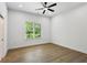 Bright bedroom featuring a ceiling fan, light hardwood floors and a window with a green view at 2438 2Nd Nw St, Atlanta, GA 30318