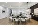 Bright dining room with modern lighting, black accent wall and view of open-concept kitchen at 2438 2Nd Nw St, Atlanta, GA 30318