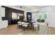 Open-concept dining area with adjacent living room and black accent wall at 2438 2Nd Nw St, Atlanta, GA 30318