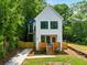 Charming two-story home with a modern farmhouse design, wood porch, and nicely landscaped front yard at 2438 2Nd Nw St, Atlanta, GA 30318