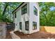 Side exterior view of home featuring clean white siding, black trim, and well kept yard at 2438 2Nd Nw St, Atlanta, GA 30318
