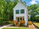 Charming two-story modern farmhouse with vertical siding, black framed windows, and a wooden porch at 2438 2Nd Nw St, Atlanta, GA 30318
