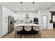 Modern kitchen with white cabinets, stainless steel appliances, and island with breakfast bar at 2438 2Nd Nw St, Atlanta, GA 30318