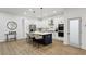 Kitchen with white cabinets, stainless steel appliances, and island with seating at 2438 2Nd Nw St, Atlanta, GA 30318