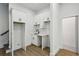 Mudroom featuring white cabinets, a black faucet, a stainless steel sink, and hardwood floors at 2438 2Nd Nw St, Atlanta, GA 30318
