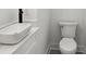 Contemporary powder room featuring a vessel sink, modern fixtures, and a sleek toilet at 2438 2Nd Nw St, Atlanta, GA 30318