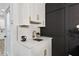 Wet bar features white cabinetry, gold fixtures, and dark accent wall at 2438 2Nd Nw St, Atlanta, GA 30318