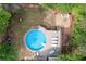 Aerial view of pool and deck with lounge chairs and a fire pit at 324 Madeline Way, Temple, GA 30179