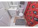 Bathroom with vanity, a shower with a Georgia Bulldogs curtain, and neutral tiling at 324 Madeline Way, Temple, GA 30179