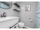 Updated bathroom with modern fixtures, floating shelves, and a framed art print at 324 Madeline Way, Temple, GA 30179