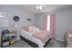 Cozy bedroom with plush bedding, gray walls and soft pink accents creating a comforting and stylish space at 324 Madeline Way, Temple, GA 30179