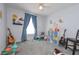 bedroom with blue accents, carpet, and a window with natural light at 324 Madeline Way, Temple, GA 30179