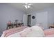 Bright bedroom with a view, featuring soft pink accents, built-in shelving, and an open closet at 324 Madeline Way, Temple, GA 30179