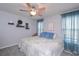 Calm and well-lit bedroom with a ceiling fan and patterned bedding at 324 Madeline Way, Temple, GA 30179