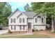 Charming two-story home with light siding, inviting front porch, and neatly landscaped yard at 324 Madeline Way, Temple, GA 30179