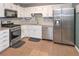 Well-equipped kitchen featuring stainless steel appliances, granite countertops, and ample cabinet space at 324 Madeline Way, Temple, GA 30179