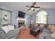 Cozy living room with fireplace, high ceilings, and a large arched window providing natural light at 324 Madeline Way, Temple, GA 30179