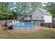 Backyard features an above ground pool with a deck and a screened porch at 324 Madeline Way, Temple, GA 30179