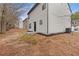 Side view of backyard and home with neutral siding at 7074 Ravenwood Ln, Lithonia, GA 30038