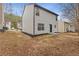Home exterior featuring a backyard and neutral siding at 7074 Ravenwood Ln, Lithonia, GA 30038