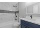 Bathroom featuring modern fixtures and stylish tile shower and a dark vanity at 7074 Ravenwood Ln, Lithonia, GA 30038