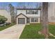 Charming two-story home features a brick accent, attached garage, and freshly landscaped front yard at 7074 Ravenwood Ln, Lithonia, GA 30038