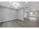 Spacious living room with modern light fixture and durable wood flooring is brightly lit at 7074 Ravenwood Ln, Lithonia, GA 30038