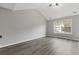 Main bedroom with vaulted ceilings and luxury vinyl flooring at 7074 Ravenwood Ln, Lithonia, GA 30038