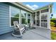 Relaxing back patio with rocking chairs, outdoor seating, and views of the well-maintained yard at 123 Woodford Ln, Canton, GA 30115