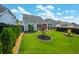 Spacious backyard with lush green grass, a black fence, and manicured landscaping for outdoor enjoyment at 123 Woodford Ln, Canton, GA 30115