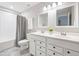 Well-lit bathroom with double vanity, white cabinets, and neutral finishes for a clean aesthetic at 123 Woodford Ln, Canton, GA 30115