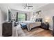 Comfortable primary bedroom featuring neutral tones, a large window, and a ceiling fan at 123 Woodford Ln, Canton, GA 30115