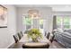 Dining area featuring modern chandelier and seating for six with views into the backyard at 123 Woodford Ln, Canton, GA 30115