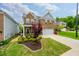 A lush green lawn and beautiful landscaping accent this two-story brick home with a two-car garage at 123 Woodford Ln, Canton, GA 30115