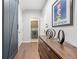 Bright hallway with modern decor, a stylish console table, and access to the laundry room at 123 Woodford Ln, Canton, GA 30115