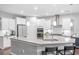 Bright kitchen featuring white cabinets, stainless steel appliances, and a spacious center island with seating at 123 Woodford Ln, Canton, GA 30115