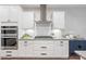 Close up of the white kitchen featuring stainless steel appliances and white subway tile backsplash at 123 Woodford Ln, Canton, GA 30115