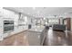 Open concept kitchen with white cabinets, stainless steel appliances, and island overlooking the living area at 123 Woodford Ln, Canton, GA 30115