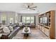 Spacious living room with a large leather sectional, custom built-ins, and ample natural light at 123 Woodford Ln, Canton, GA 30115
