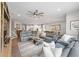 Spacious living room with plush seating, a ceiling fan, and an open view to the adjacent kitchen at 123 Woodford Ln, Canton, GA 30115