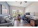 Functional home office space featuring a sofa, desk, and windows for natural light at 123 Woodford Ln, Canton, GA 30115