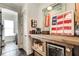 Rustic bar area with a wine cooler, adding charm and functionality to the home at 164 Inwood Walk, Woodstock, GA 30188