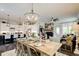 The dining area features an open concept with elegant lighting and view of fireplace at 164 Inwood Walk, Woodstock, GA 30188